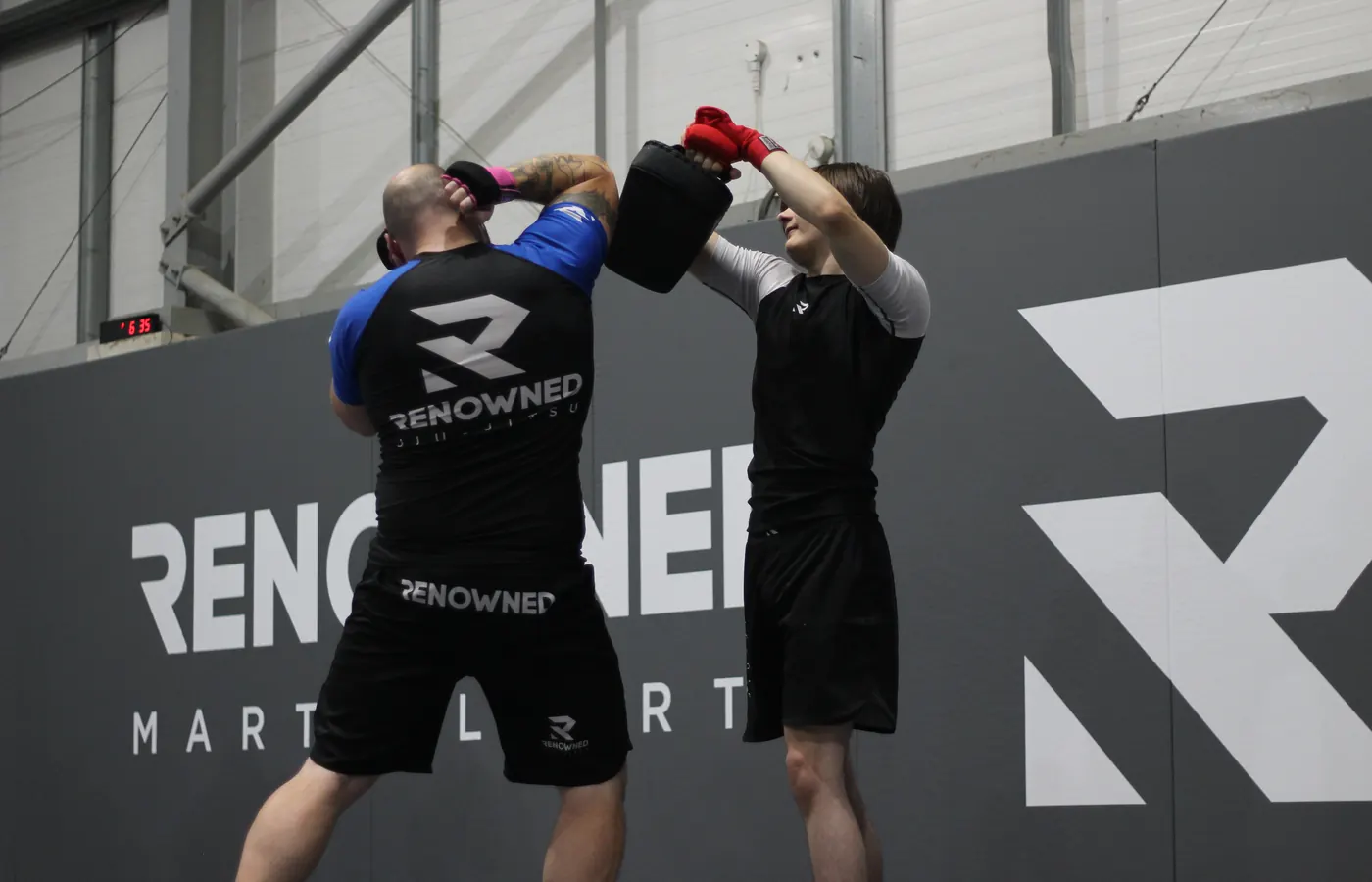 Two adults working pads together in a kickboxing class